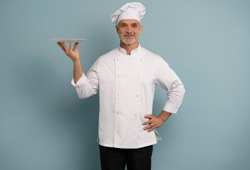 Portrait of chef, empty plate and smile, presenting menu special promo deal or restaurant product placement