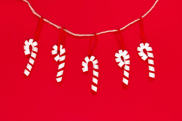 Toy candies made of felt isolated on the red background with copy space. The atmosphere of...