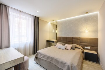 cozy bedroom with a large bed, soft lighting, and neutral colors, creating a relaxing atmosphere
