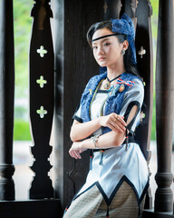 Pretty Asian women in ancient traditional Thai dress. Beautiful Thai dresses in Lanna style make merit according to tradition. Fashion portraits at the Chedi Luang temple in Chiang Mai, Thailand.