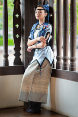 Pretty Asian women in ancient traditional Thai dress. Beautiful Thai dresses in Lanna style make merit according to tradition. Fashion portraits at the Chedi Luang temple in Chiang Mai, Thailand.
