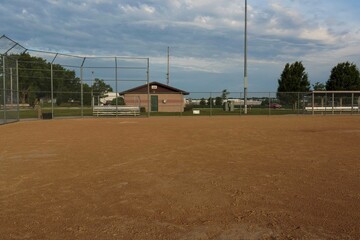 a view from first base to home plate and the third base dugout on a baseball field