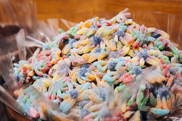 Background of colorful chewy gelatin sweets covered with sugar in a candy shop.