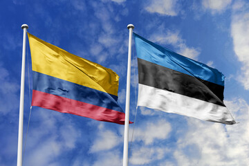 Colombia and Estonia flags proudly displayed against a bright blue sky, symbolizing international...