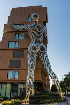 Prague, Czech Republic - September 21, 2024: Rear view of giant mirrored Lilith sculpture by Czech artist David Cerny attached to modern residential building in Karlin. Urban art meets architecture.