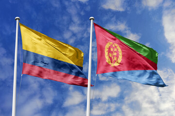 Colombia and Eritrea flags proudly waving side by side against a brilliant blue sky, symbolizing...