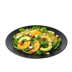 A black plate presenting fresh arugula salad topped with juicy orange slices, creamy avocado, and crunchy almonds