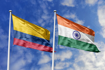 Colombia and India flags majestically unfurling against a backdrop of a beautiful blue sky,...