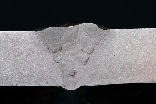 Weld macroetch sample. Cross-section reveals fusion zone, HAZ, inclusions, lack of fusion. Used in welding inspection, NDT training, metallography, and quality control evaluation.