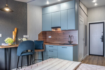 Modern small kitchen design in a cozy apartment with elegant decor and integrated appliances