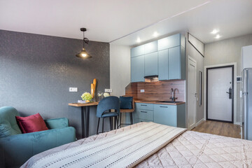Bright and inviting studio apartment featuring a stylish kitchen, comfortable seating area, and...