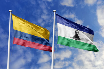 Colombian and Lesotho flags proudly wave together, symbolizing international relations, friendship, and cultural exchange.