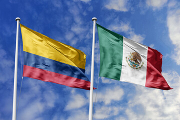 Colombian and Mexican flags proudly wave together, symbolizing international relations, friendship,...