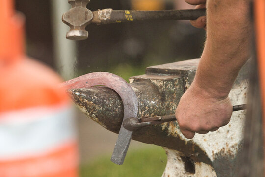 blacksmith forging a horseshoe