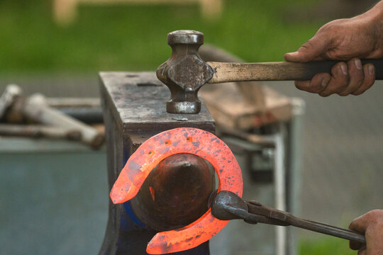 hammer hitting horseshoe  - Powered by Adobe