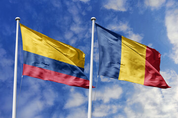 Waving flags of Colombia and Chad (or Romania) against a vibrant blue sky, symbolizing...