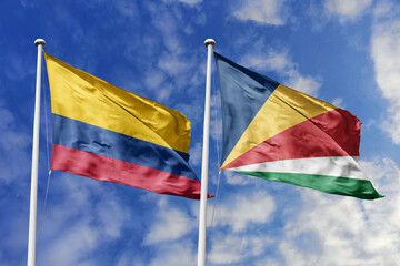 Waving flags of Colombia and Seychelles against a vibrant blue sky, symbolizing international...