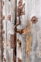 Old wooden door with wrought iron details in Villanueva de los Infantes town