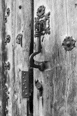Old wooden door with wrought iron details in Villanueva de los Infantes town