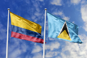 Waving flags of Colombia and Saint Lucia against a vibrant blue sky, symbolizing international...