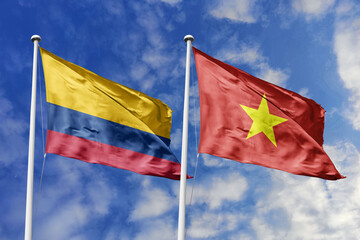 The Striking National Flags of Colombia and Vietnam Waving Energetically Together Under a Bright Blue Sky, Symbolizing Growing Diplomatic Relations and the Spirit of Global Connection.