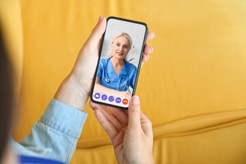 Woman video chatting with doctor from home, closeup. Concept of telemedicine