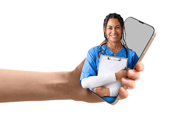 Young African-American female doctor with stethoscope and clipboard on white background
