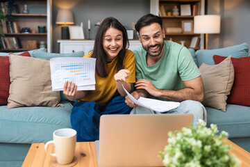 Successful young business people working together in home office. Freelance couple teamwork...