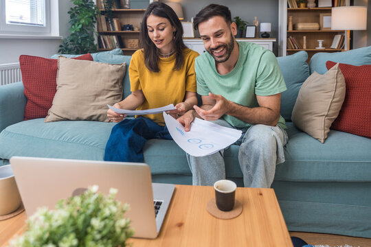 Successful young business people working together in home office. Freelance couple teamwork businessman and businesswoman startup concept video call presentation on laptop computer and webcam