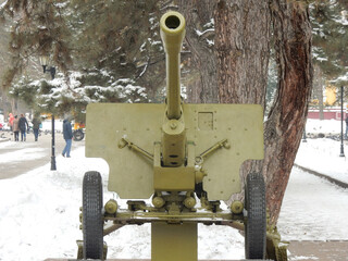 Howitzer Gun and Statue in Paniflov Park , Almaty in winter
