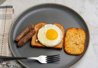 fried egg on toast  with breakfast links