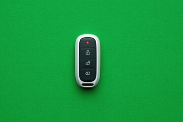 Remote control with buttons sits on a vibrant surface