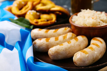 Plate with tasty Bavarian sausages and sauerkraut on table. Oktoberfest celebration