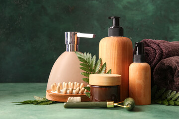 Set of spa supplies on green background