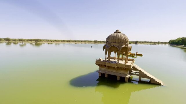 Gadsisar Lake in Jaisalmer shimmers under the Rajasthan sun, reflecting ancient temples and serene pavilions. Golden light, calm waters, and migratory birds add to its timeless desert charm