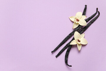 Aromatic vanilla sticks and flowers on lilac background