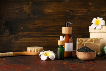Composition with spa accessories and Christmas gifts on table against wooden background