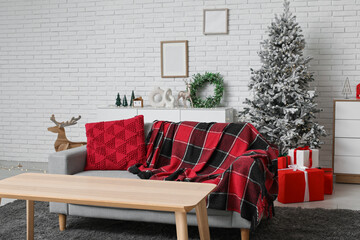 Interior of stylish living room with beautiful Christmas tree and gift boxes
