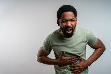 Handsome Young Black Man with Stomach Pain, Painful Grimace, Isolated Background, Abdominal...