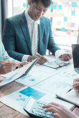 Entrepreneur in suit brainstorming about marketing strategy in company conference room. Brainstorming about business group project analysis plan. Vertical image.