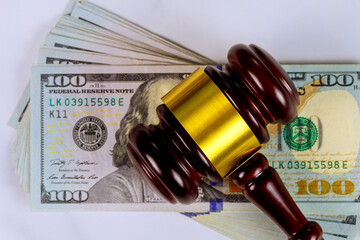 Justice gavel on pile of US dollar money symbolizes legal issues financial disputes in judicial system.