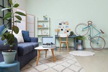 Interior of room with mood board, workplace and bicycle