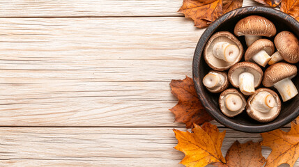 Shiitake mushrooms in wooden bowl surrounded by autumn leaves on rustic wooden background.