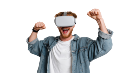 Excited young man wearing virtual reality headset with hands raised in celebration, isolated on white background.
