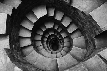 Endless spiral staircase viewed from above, showcasing a mesmerizing architectural design in a historic building