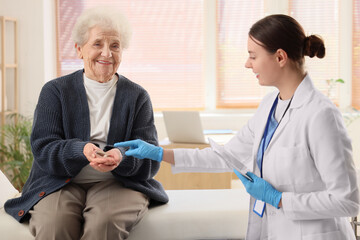 Senior woman with hearing aid and doctor in clinic