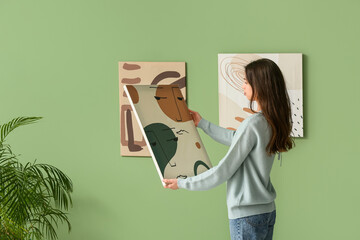Young woman with abstract painting at art gallery exhibition