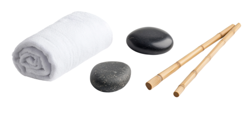 Set of spa elements rolled white towels, bamboo sticks, and black massage stones