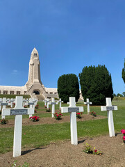View of the Douaumont Ossuary from the military cemetery in Verdun, France, under a clear sky, commemorating World War I soldiers