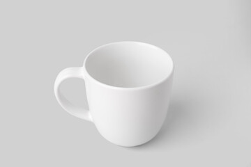 White ceramic cup on grey background